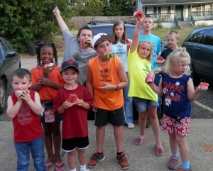 Pilgrim’s 2013 VBS children, many wearing their VBS t-shirts, prepare for their long awaited watermelon-seed spitting contest as they pose for a group picture on the last night. From left to right, they are Zylan Ellis, Sanyia Hopkins, Cooper Sampson, Clay Ellis, Luke Land, Emma Morton, Kylee Vineyard, Ben Morton, John Morton, and Mikaela Haufler.