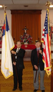 Pilgrim Members Leland Dean (left, a Marine) and Bob Abraham (right, a Navy veteran) pose with flags on July 10, 2005, at the congregation’s Service of Thanksgiving for God and Country. Both men served under combat conditions during World War II.