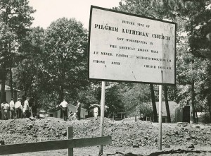 A sign on the corner of Broadway and Florey in 1953 told passersby both what was coming to the location and where the congregation was meeting at that time. A note on the back of a copy of this photo says it was taken at the start of construction.